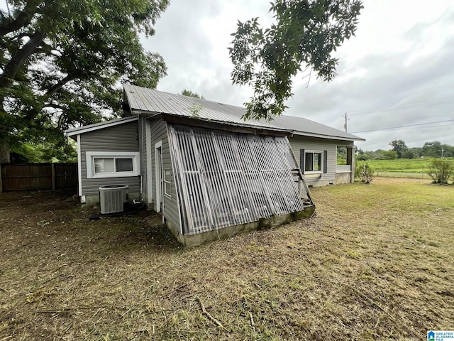 view of outdoor structure with cooling unit and a yard