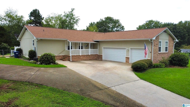 ranch-style house with a garage, a front yard, and covered porch