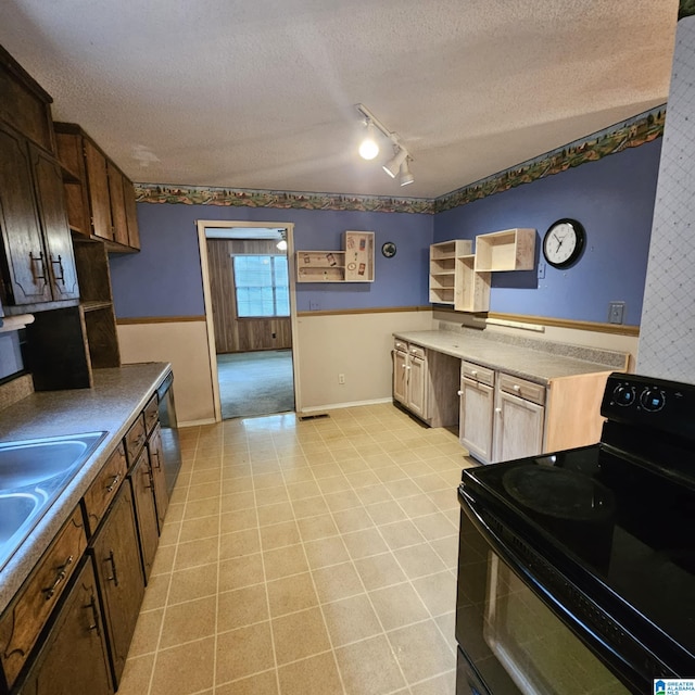 kitchen featuring a textured ceiling, electric range, and track lighting