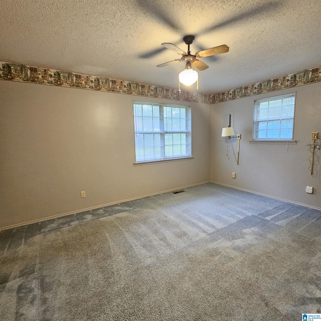 carpeted empty room with a textured ceiling and ceiling fan