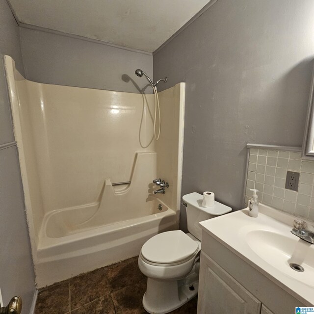 full bathroom with washtub / shower combination, backsplash, tile patterned floors, toilet, and vanity