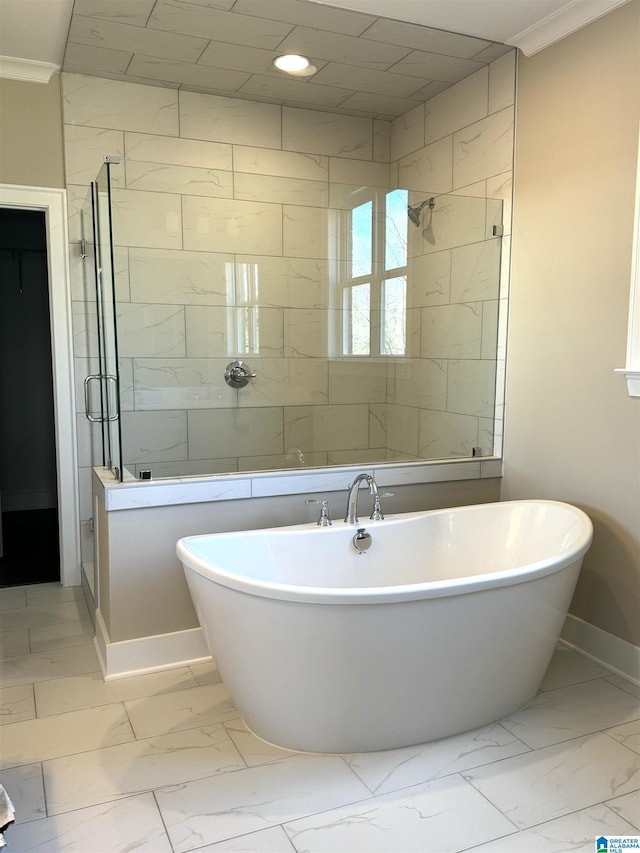 full bath featuring baseboards, a freestanding bath, marble finish floor, ornamental molding, and a stall shower