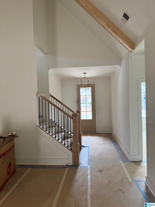 entryway featuring high vaulted ceiling, baseboards, stairs, and visible vents