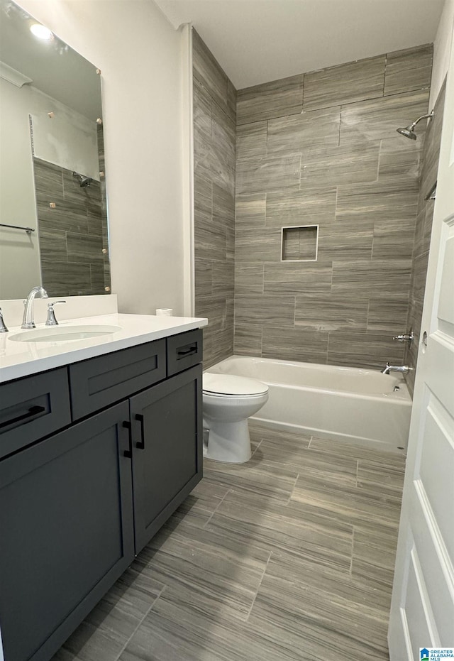 full bathroom featuring toilet, bathing tub / shower combination, and vanity