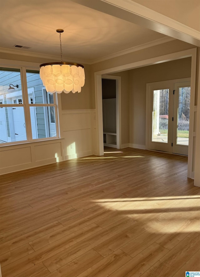 empty room featuring crown molding and hardwood / wood-style floors