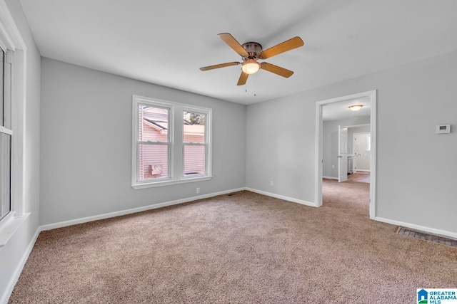 empty room featuring light colored carpet and ceiling fan