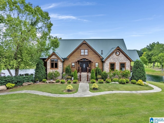 view of front of house featuring a water view and a front lawn