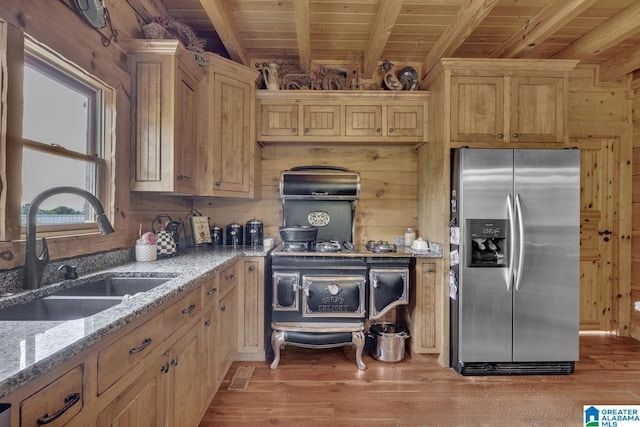 kitchen featuring sink, stainless steel fridge, wooden ceiling, beamed ceiling, and wood walls