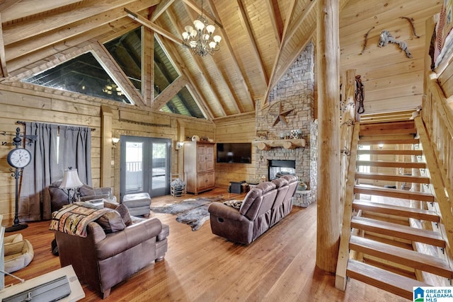 living room featuring hardwood / wood-style floors, beam ceiling, wooden walls, high vaulted ceiling, and wooden ceiling