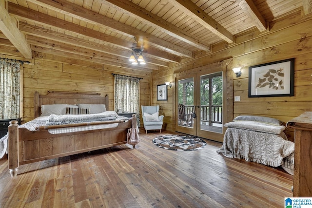 bedroom with wooden walls, beamed ceiling, hardwood / wood-style flooring, access to outside, and wood ceiling