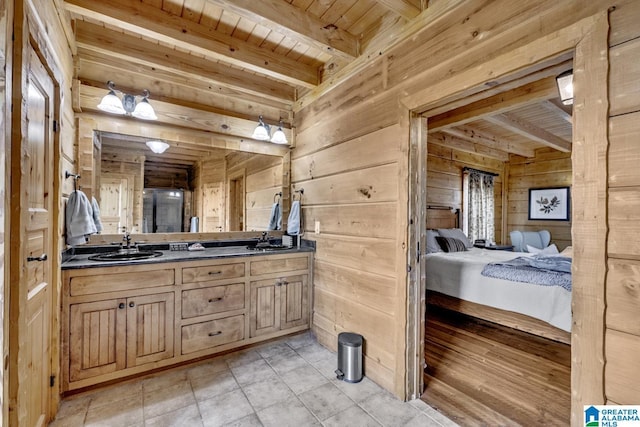 bathroom with vanity, beam ceiling, wooden ceiling, and wood walls