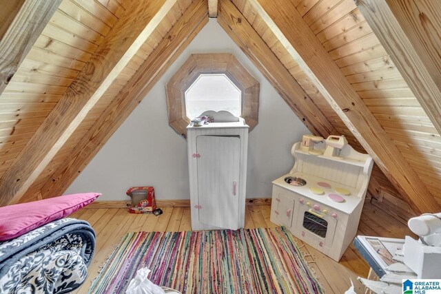 rec room featuring lofted ceiling with beams, light hardwood / wood-style flooring, and wooden ceiling