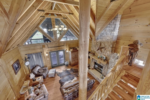 living room with french doors, wooden ceiling, a notable chandelier, beamed ceiling, and hardwood / wood-style floors