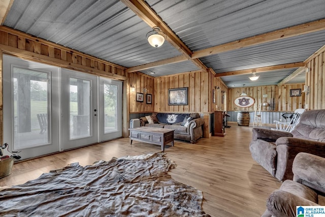 living room with wooden walls and light hardwood / wood-style flooring