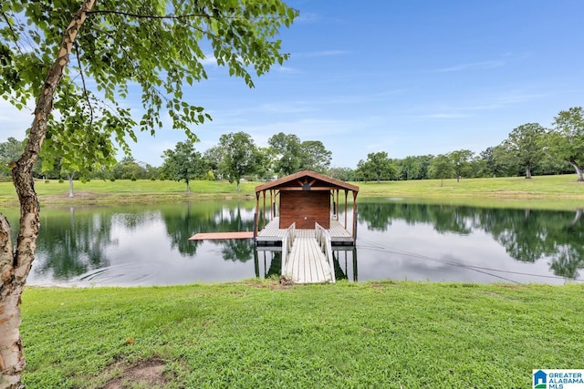 view of dock featuring a lawn and a water view