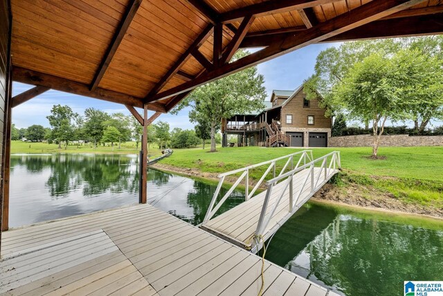 dock area featuring a lawn and a water view