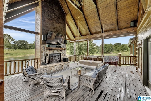 deck with an outdoor living space with a fireplace