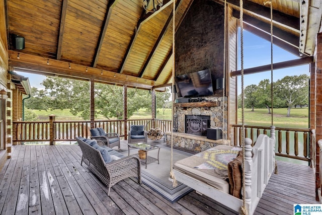 exterior space featuring vaulted ceiling with beams, wood ceiling, and an outdoor stone fireplace