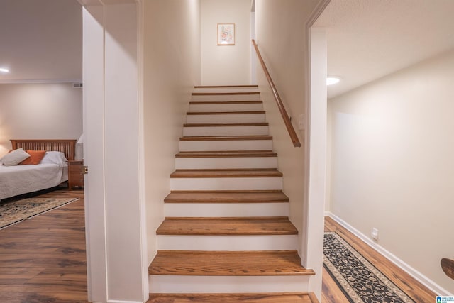 stairway featuring hardwood / wood-style floors