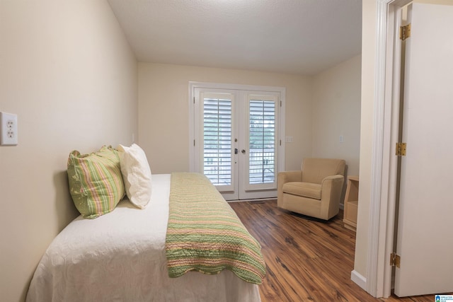 bedroom with french doors, access to exterior, and dark hardwood / wood-style flooring