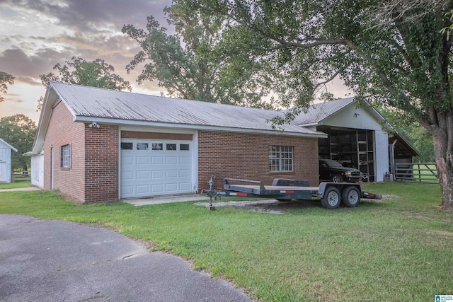 view of front of property featuring an outbuilding and a lawn