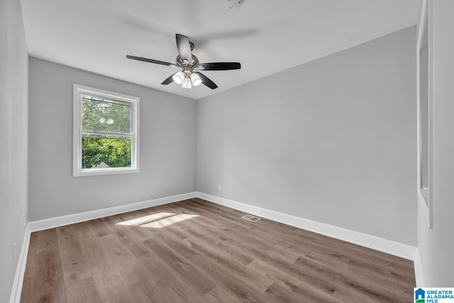 unfurnished room with ceiling fan and hardwood / wood-style flooring