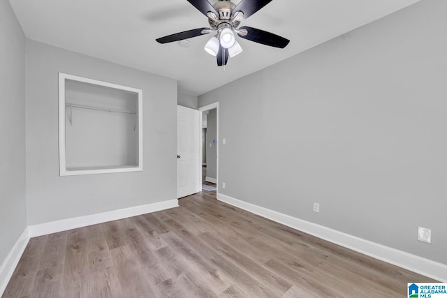 spare room with light wood-type flooring and ceiling fan