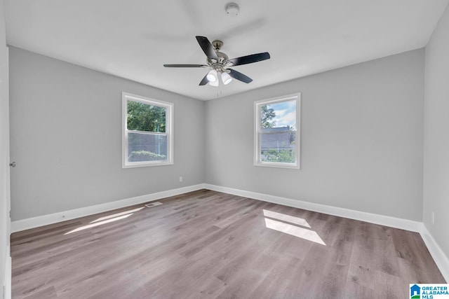 empty room with ceiling fan and wood-type flooring