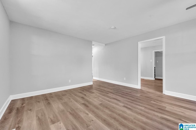 unfurnished room with light wood-type flooring