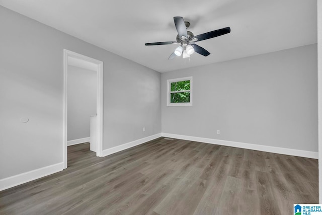 unfurnished room with ceiling fan and wood-type flooring