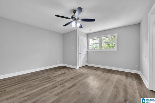 empty room featuring ceiling fan and hardwood / wood-style flooring