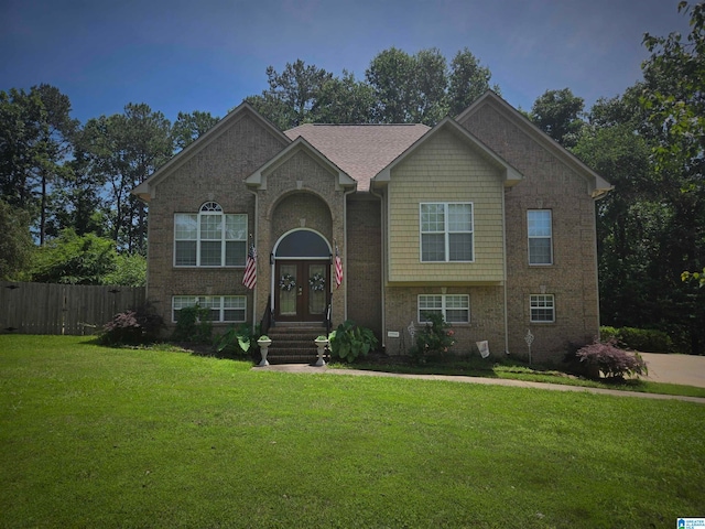 raised ranch featuring a front lawn