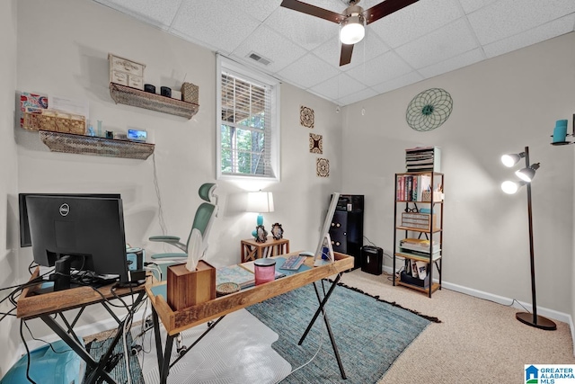 home office featuring ceiling fan, a drop ceiling, and carpet floors