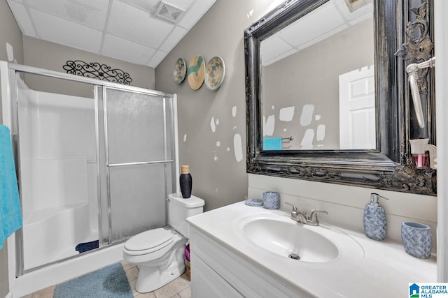 bathroom featuring walk in shower, toilet, tile patterned floors, a paneled ceiling, and vanity