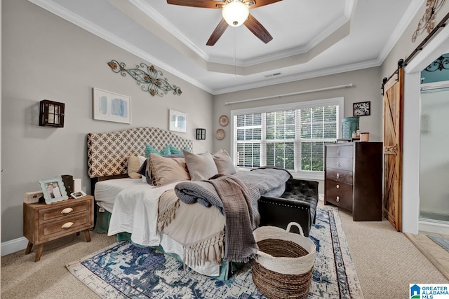 bedroom with ceiling fan, a barn door, light carpet, and a tray ceiling