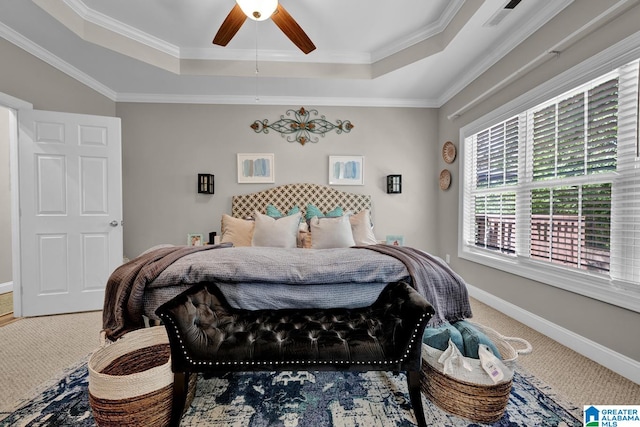 bedroom with ceiling fan, a tray ceiling, and carpet floors