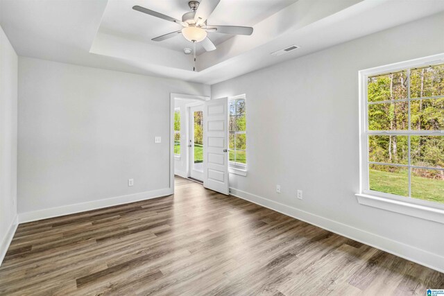 unfurnished living room with ceiling fan and dark hardwood / wood-style flooring