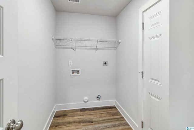 clothes washing area featuring washer hookup, dark hardwood / wood-style flooring, hookup for an electric dryer, and gas dryer hookup