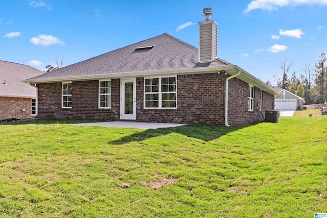 rear view of house with a lawn, central air condition unit, and a patio area