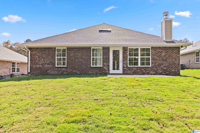 back of house featuring a lawn