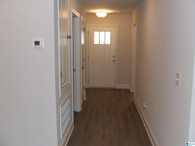 hallway with dark hardwood / wood-style floors