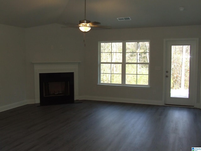 unfurnished living room featuring ceiling fan, lofted ceiling, plenty of natural light, and dark hardwood / wood-style floors