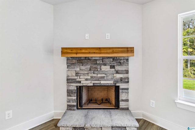 details featuring a stone fireplace and hardwood / wood-style floors