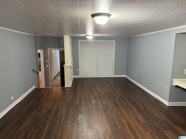 unfurnished bedroom with crown molding, dark wood-type flooring, and a textured ceiling