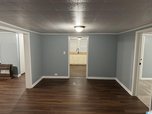 spare room with sink, ornamental molding, dark hardwood / wood-style floors, and a textured ceiling