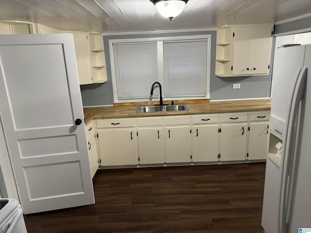 kitchen with sink, white refrigerator with ice dispenser, dark hardwood / wood-style floors, and white cabinets