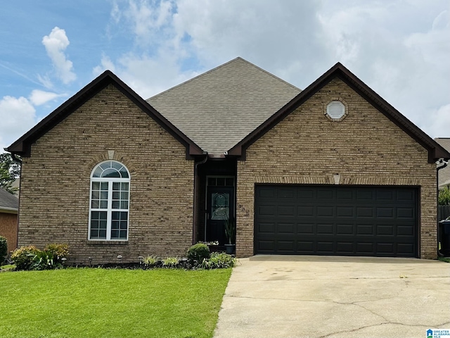 view of front of house with a garage and a front yard