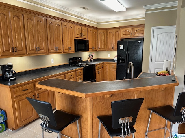 kitchen with light tile patterned flooring, a kitchen bar, crown molding, kitchen peninsula, and black appliances