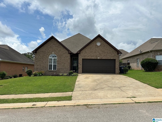 view of front of property with a garage and a front lawn