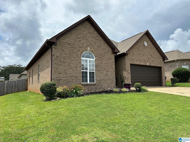 view of front of property featuring a garage and a front lawn